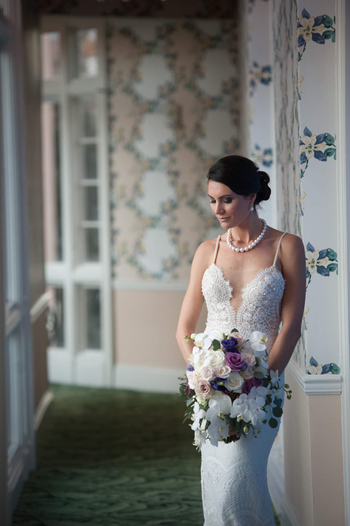 Bride leading against the wall in a beautiful hallway at the Broadmoor Hotel in Colorado Springs