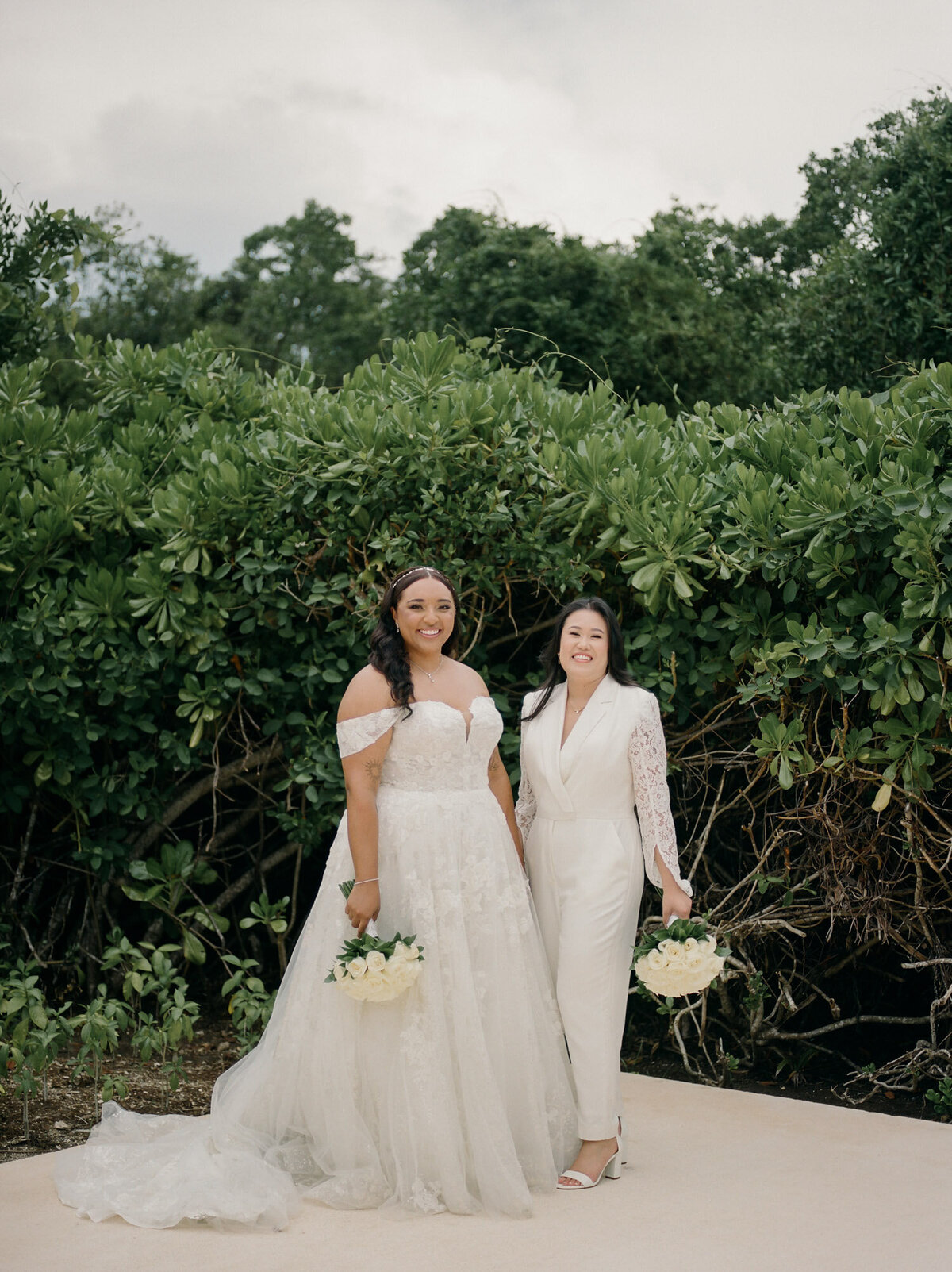 two brides same sex wedding in Mexico, chic pantsuit and dress, Playa del Carmen