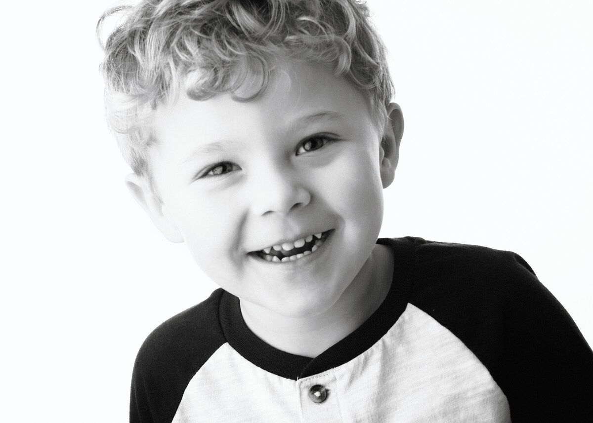 Close up of a boy smiling in Black & White