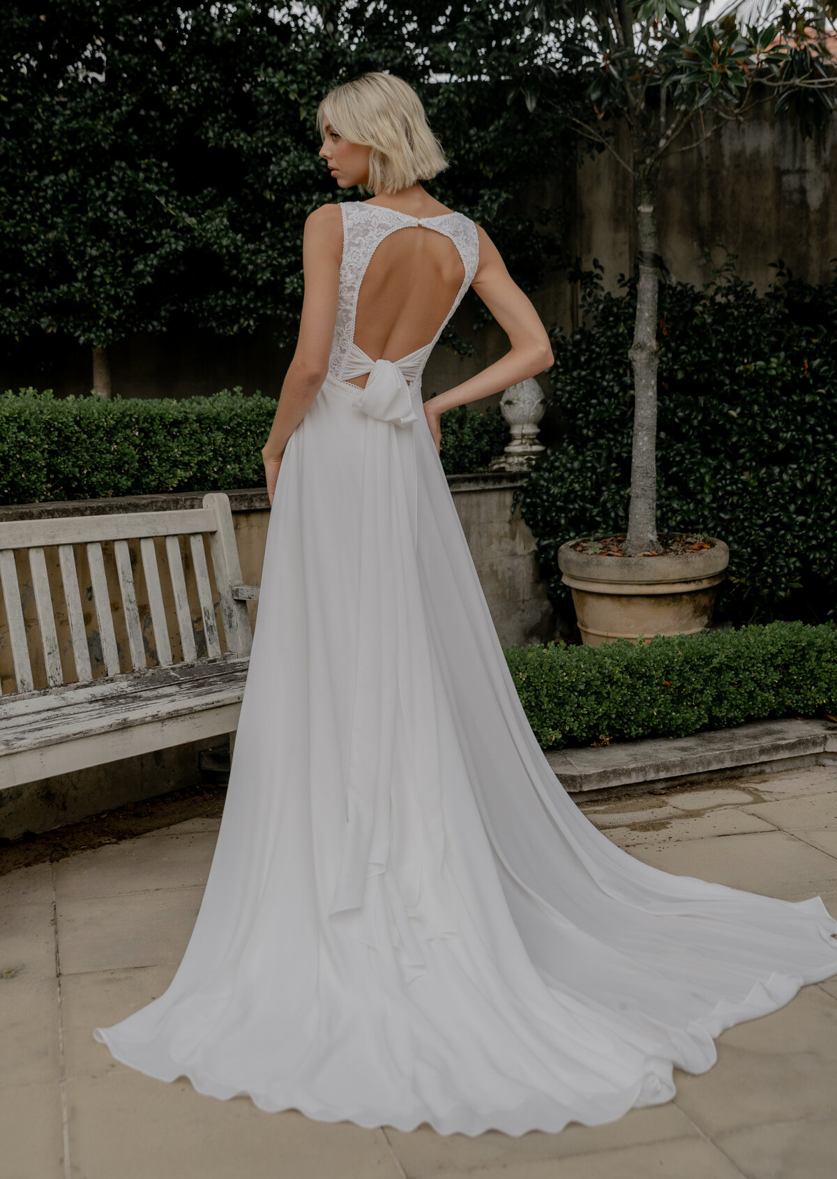 Back of wedding dress next to bench