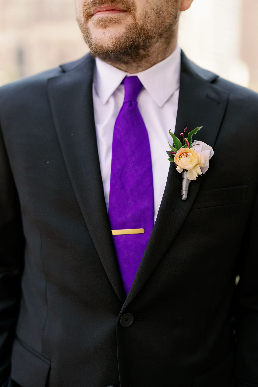 summer ranunculus boutonniere groom matching bride