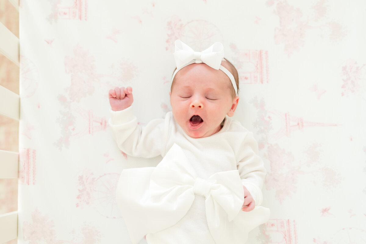 Baby yawning in crib