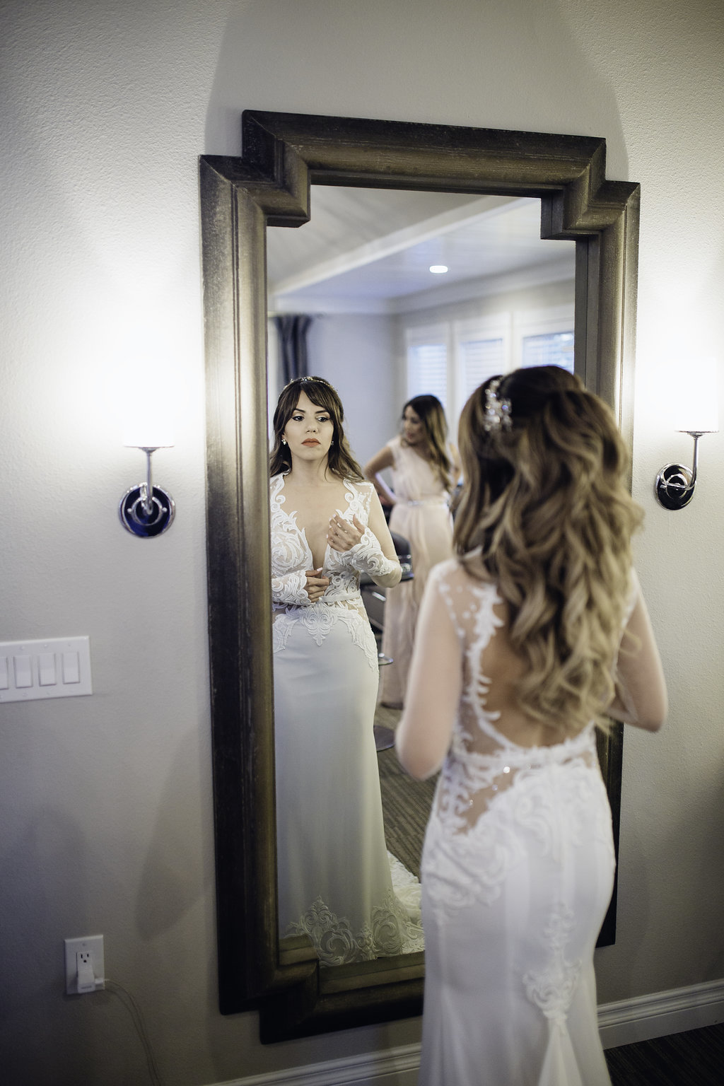 Wedding Photograph Of Woman Fixing Her Dress in The Mirror Los Angeles