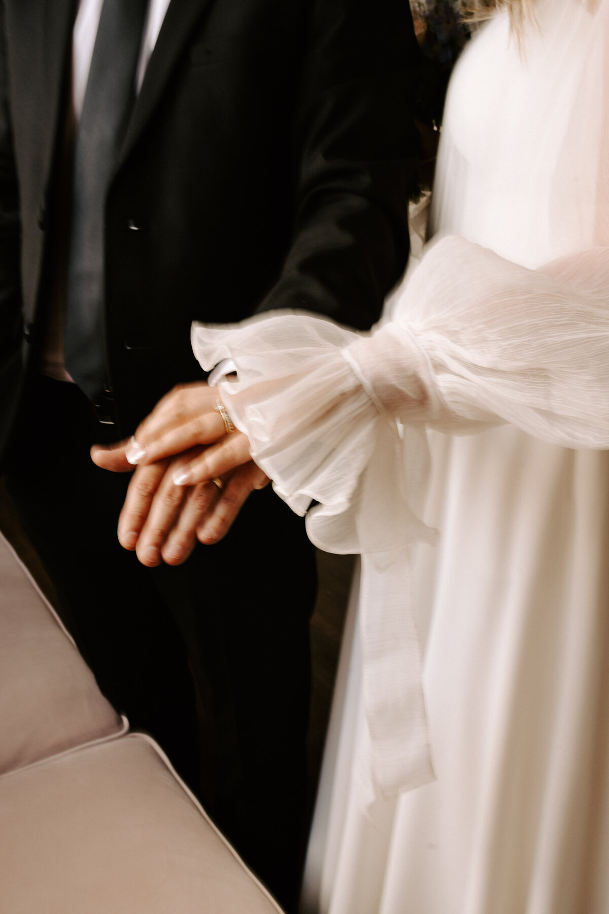 Bride, placing her hand on the grooms hand. Grand Ivory 