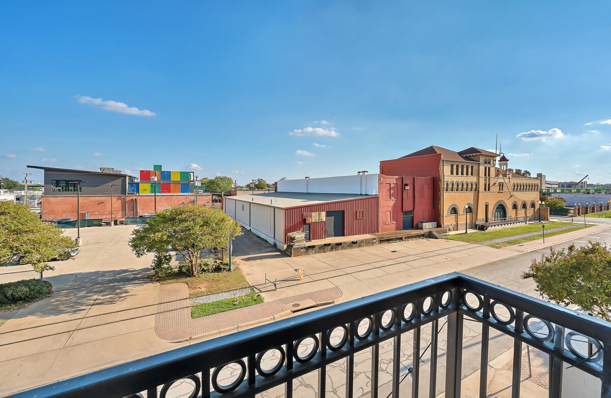 Stunning balcony view at this one-bedroom, one-bathroom vintage industrial condo with Smart TV, free Wi-Fi, and washer/dryer located in downtown Waco, TX.