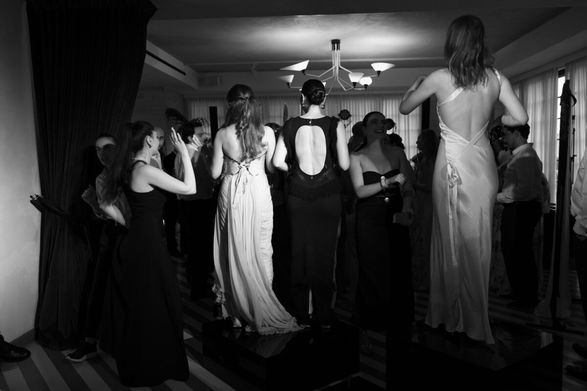 Guests holding up shoes and dancing with wild energy at Soho House Rome


