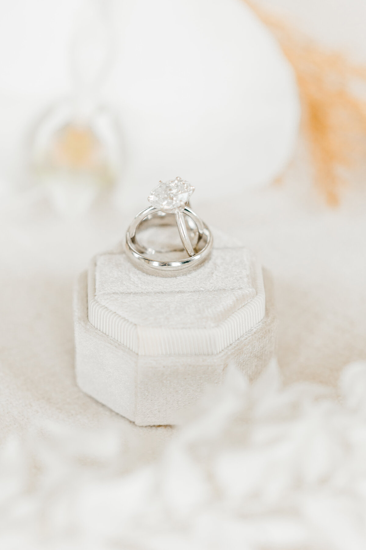 engagement ring and wedding bands on velvet ring box
