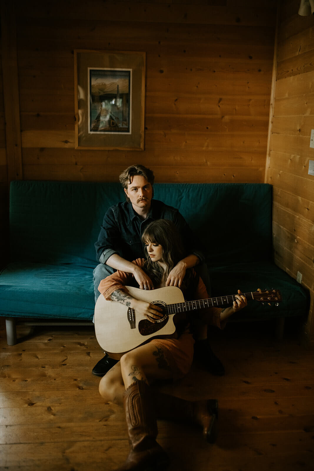 Woman-playing-guitar-with-man-sitting-on-couch (2)