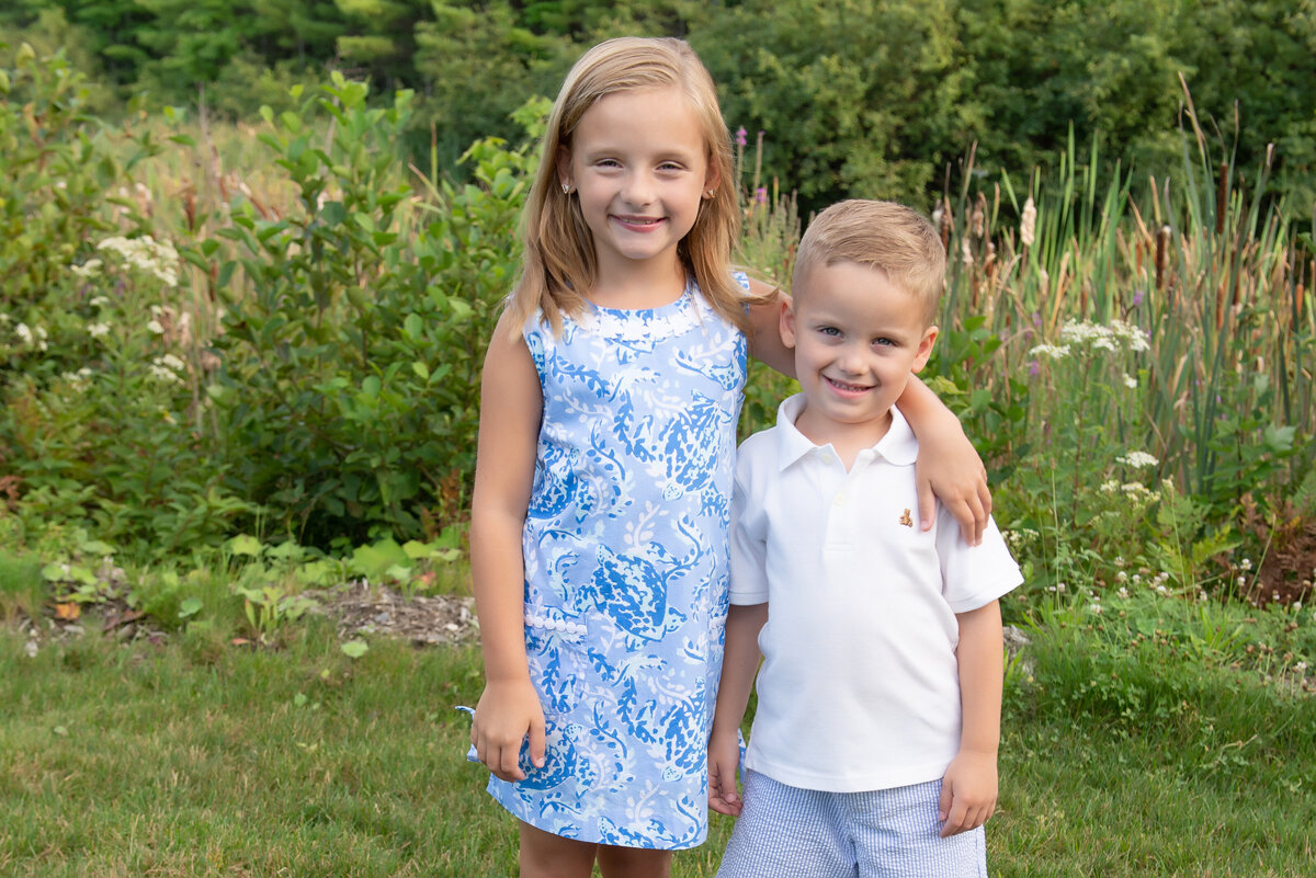 Siblings smiling for portrait at Old Marsh Country Club Wells Maine