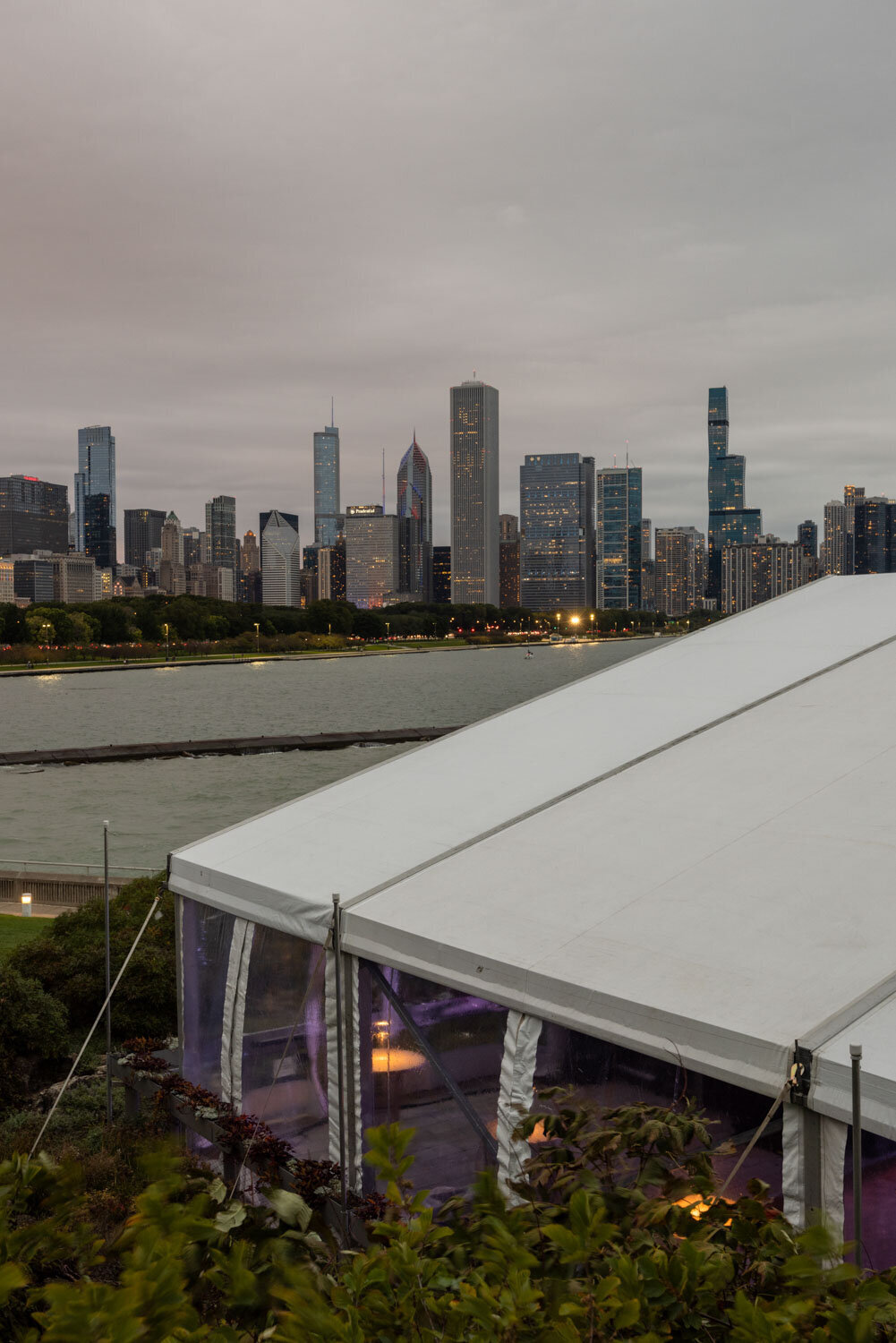 Tent with view of city skyline at dusk