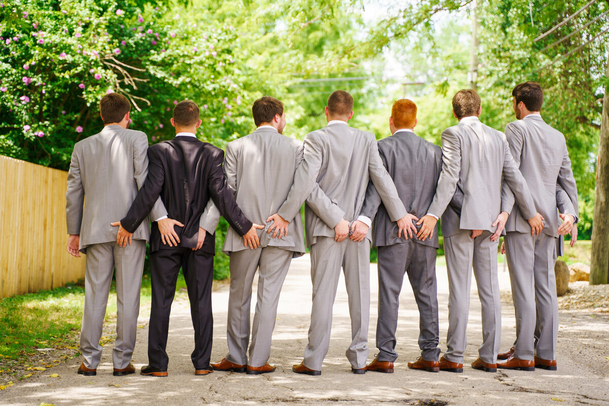 Groom and groomsmen touch each other's butt's at a wedding at 1883 Locale in Reynoldsburg, Ohio.