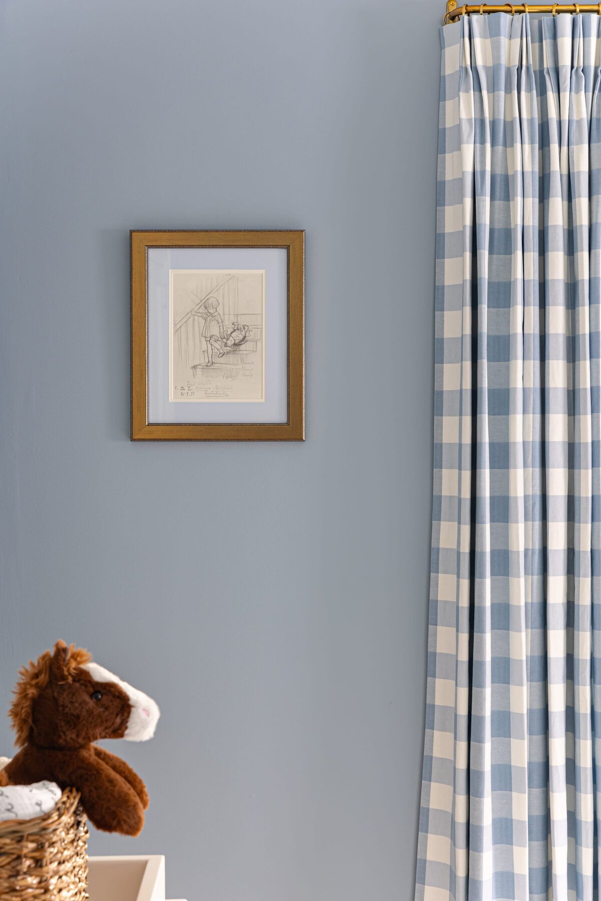 melinda chesson interiors bay street nursery with painted blue walls and stuffed animal horse