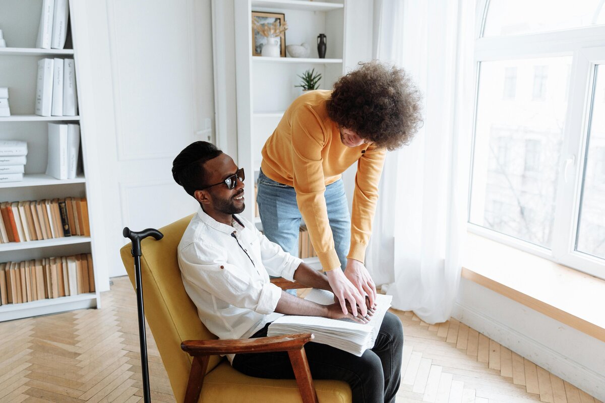 Man sitting on chair receiving support