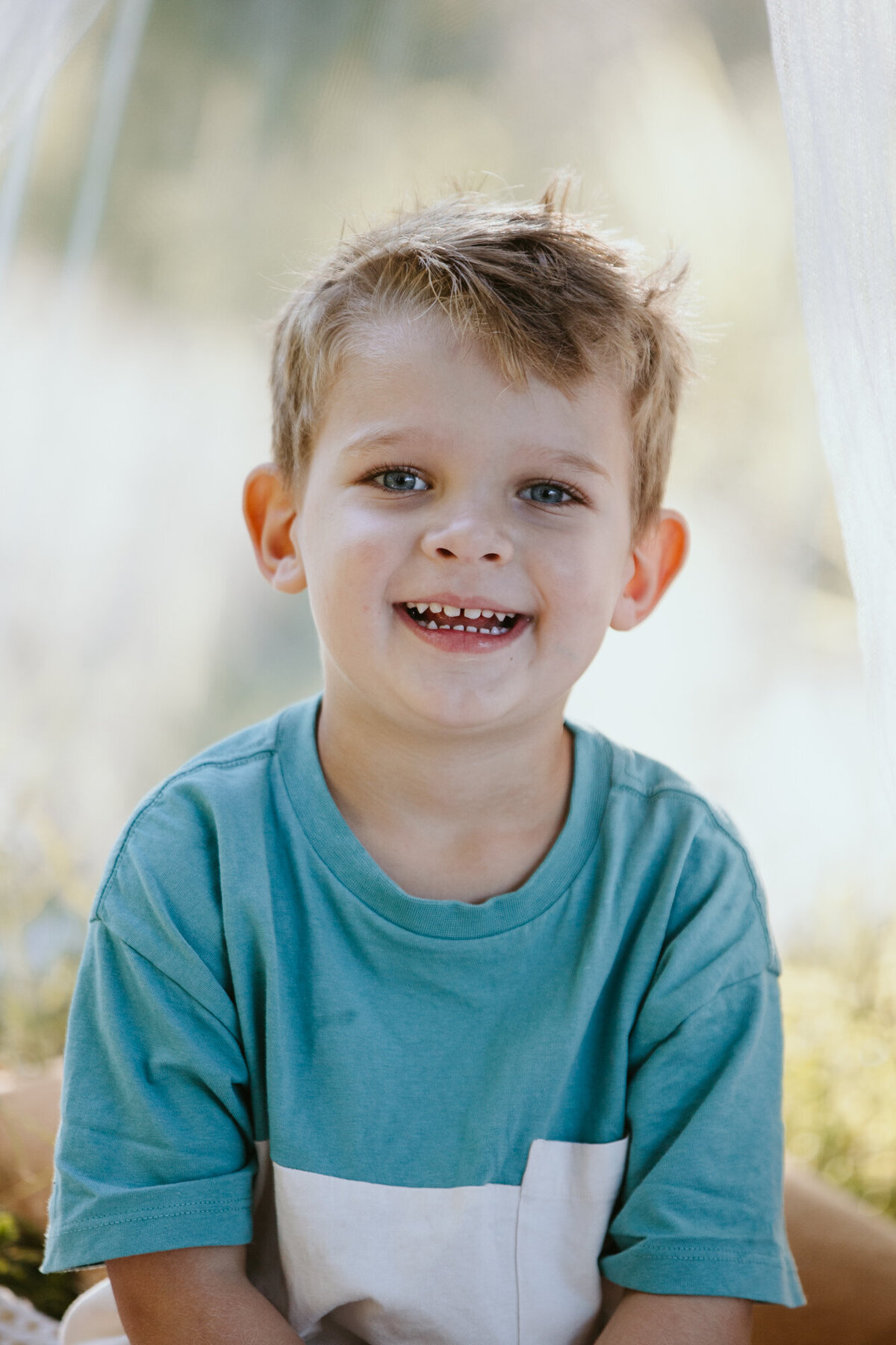 Blue eyed boy with blond hair smiling