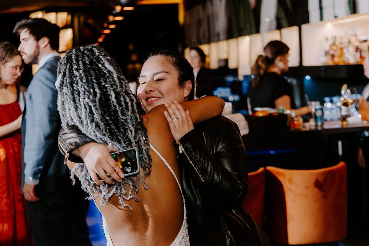 Bride hugging her guest