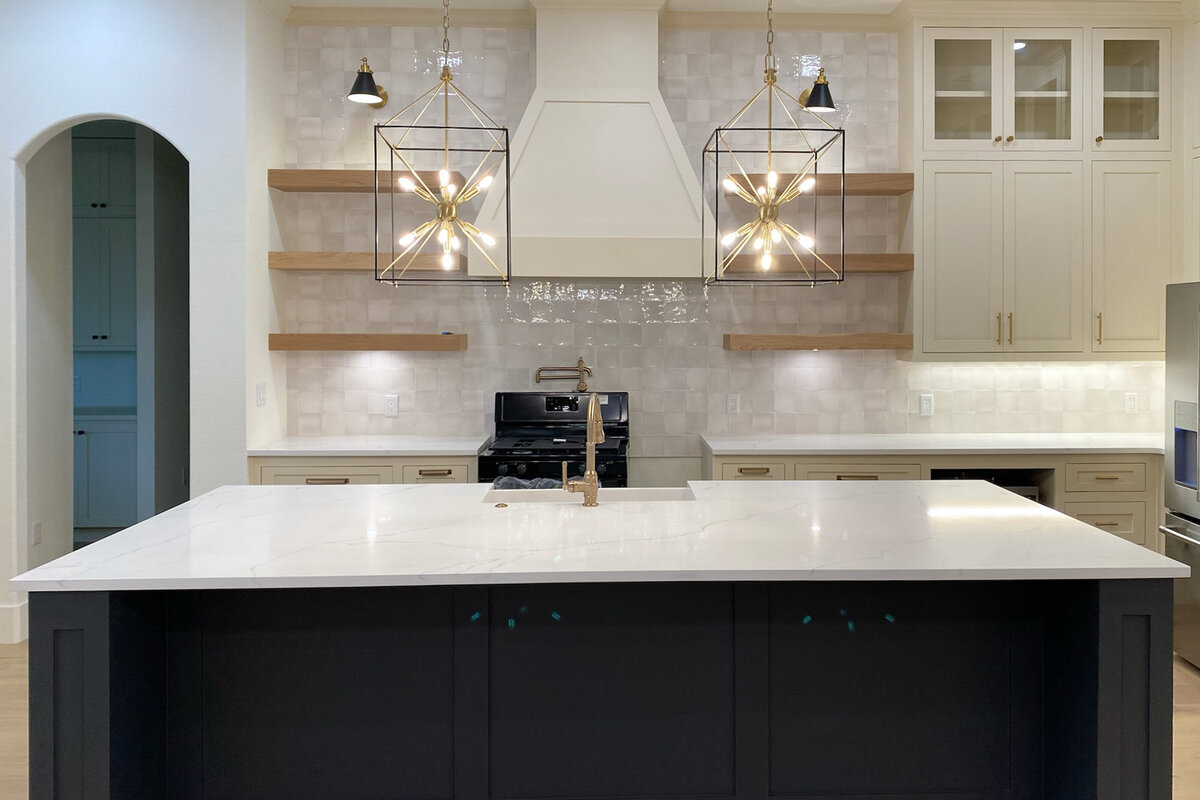 large kitchen island with black cabinet and white countertops