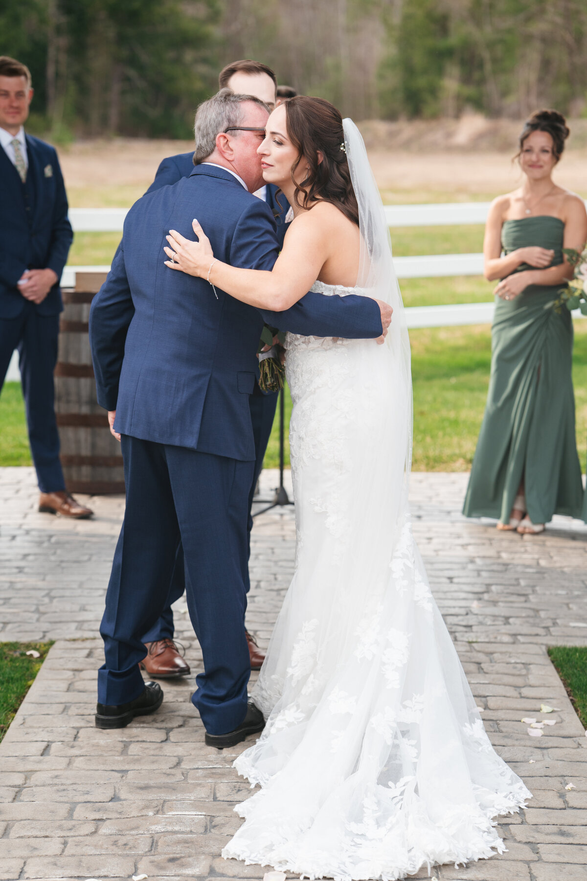 Couple exchanging vows under a floral arch in New England