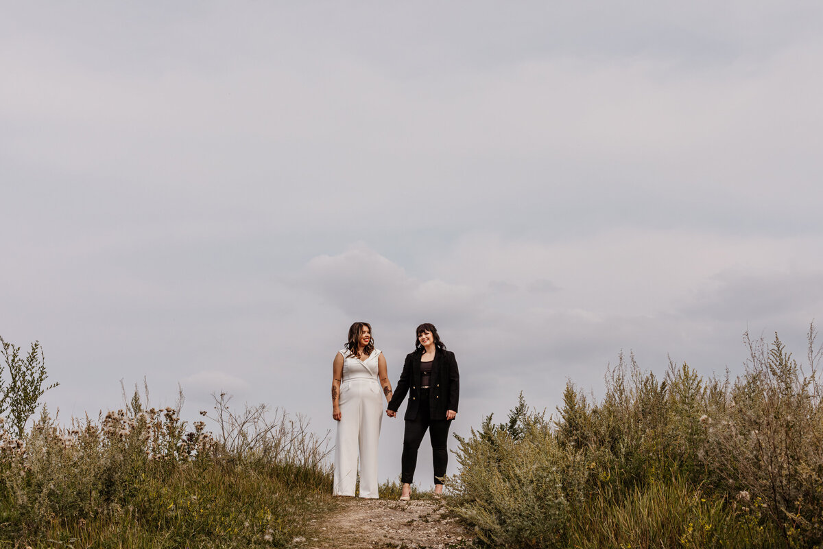 Creative portrait of brides on their wedding day at Fort Whyte Alive in summer