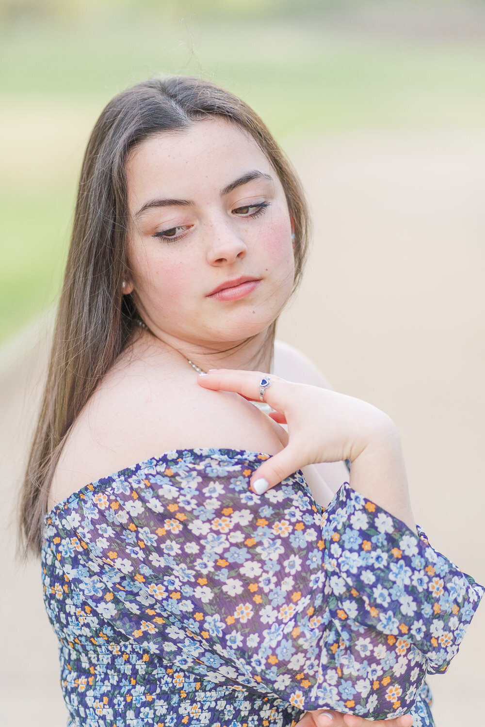 high school girl looking over her shoulders during senior photography in Springfield, VA