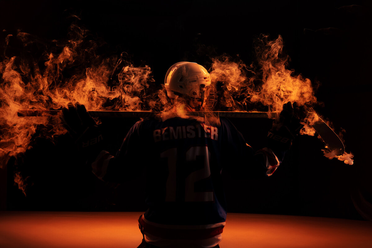 st-louis-senior-photographer-teen-hockey-player-with-hockey-stick-on-fire
