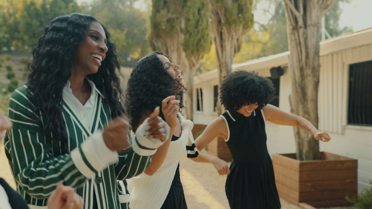 three women dancing.