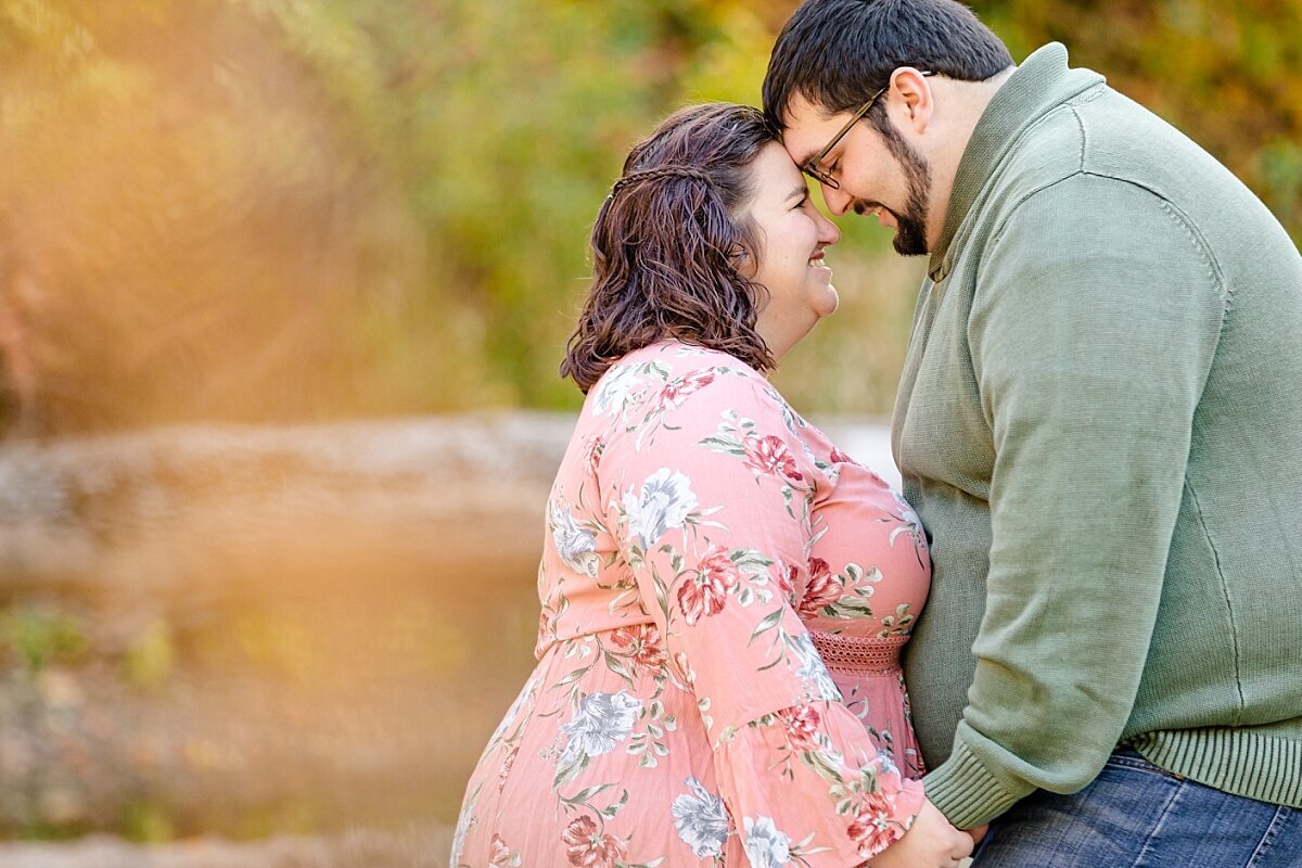 engaged-couple-resting-foreheads-together-columbus-park-michigan