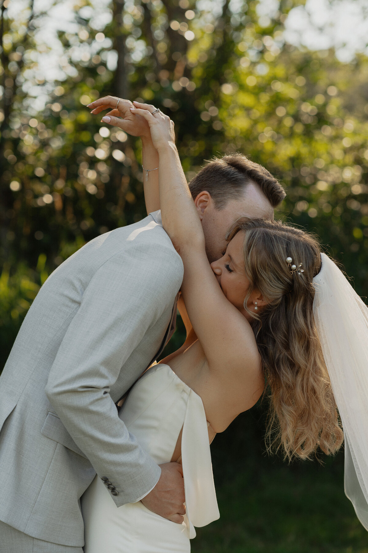 Bride and Groom snuggled up during their wedding portraits in Comox by Latitude 49 Photography