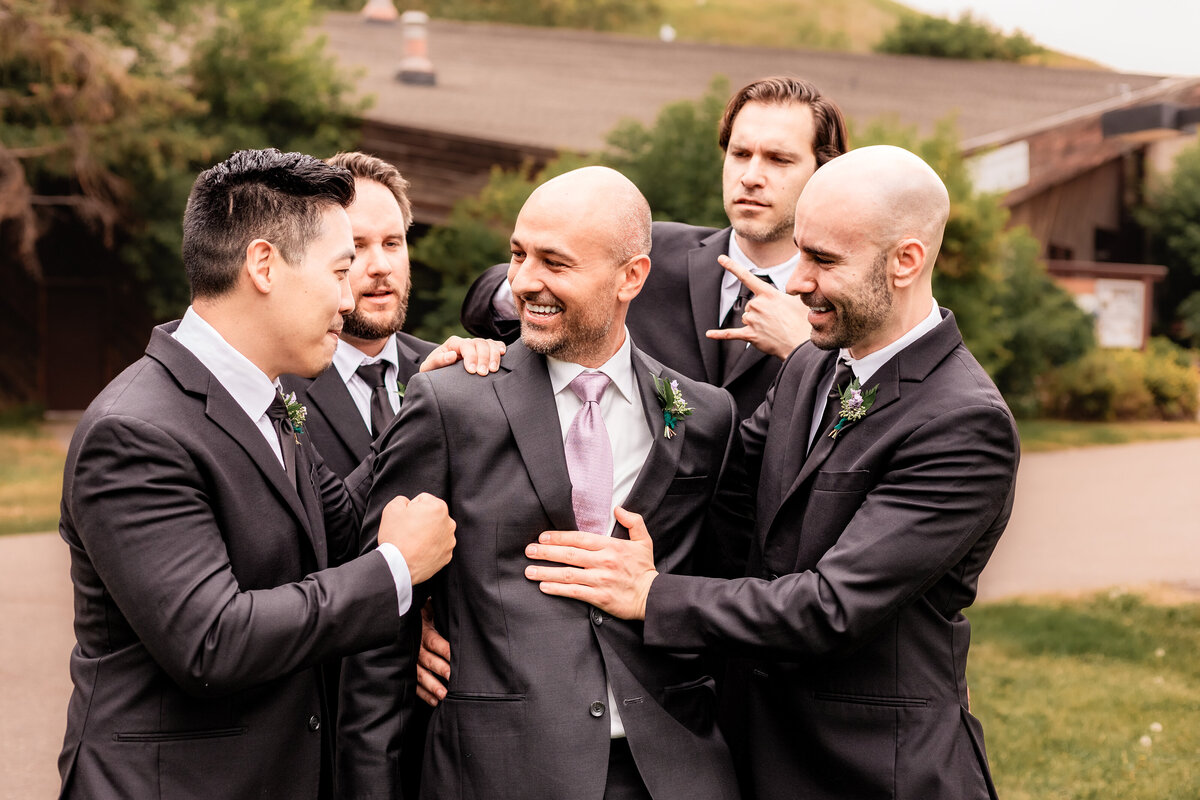 Groomsmen surround the groom on his wedding day