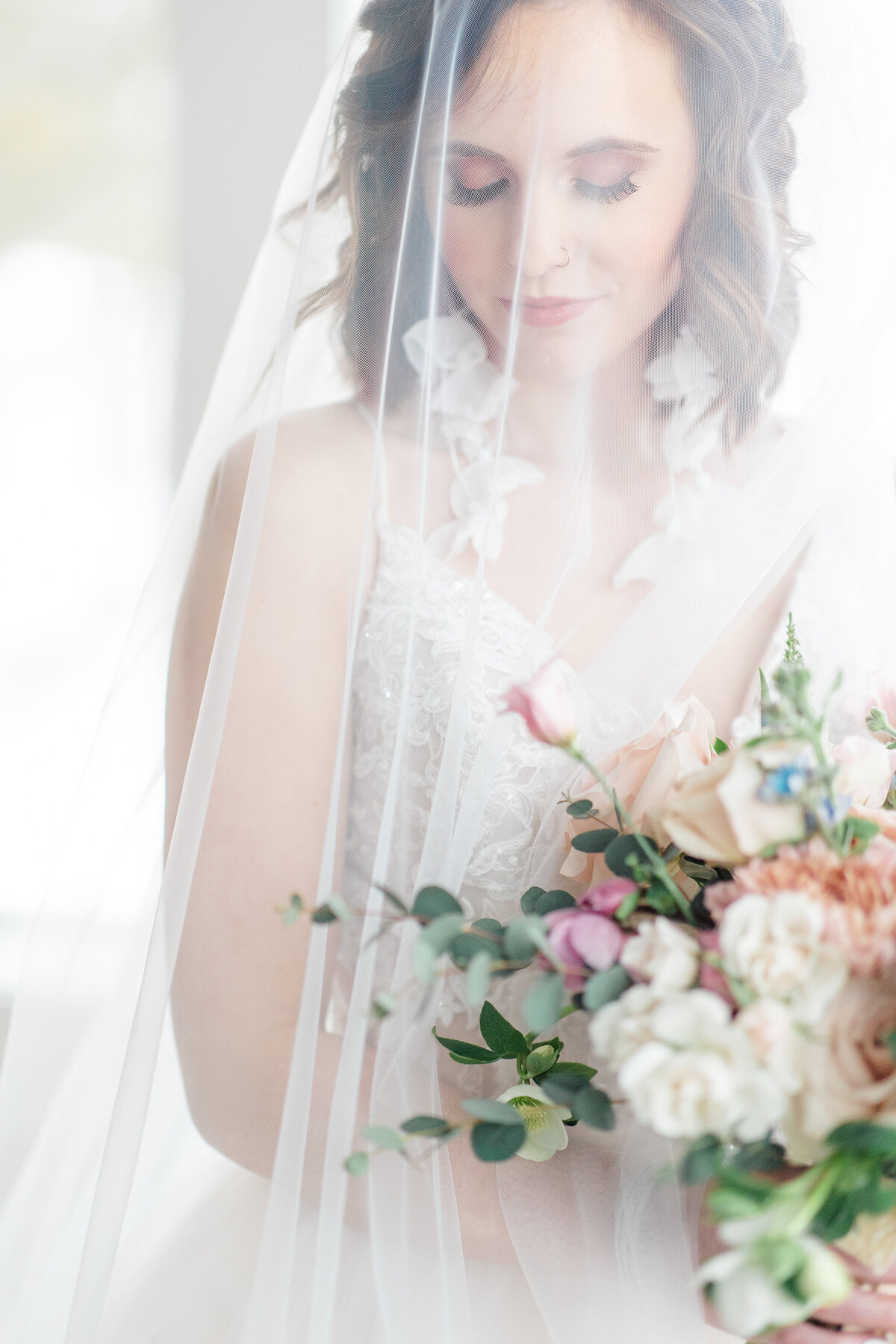 bride posed with veil