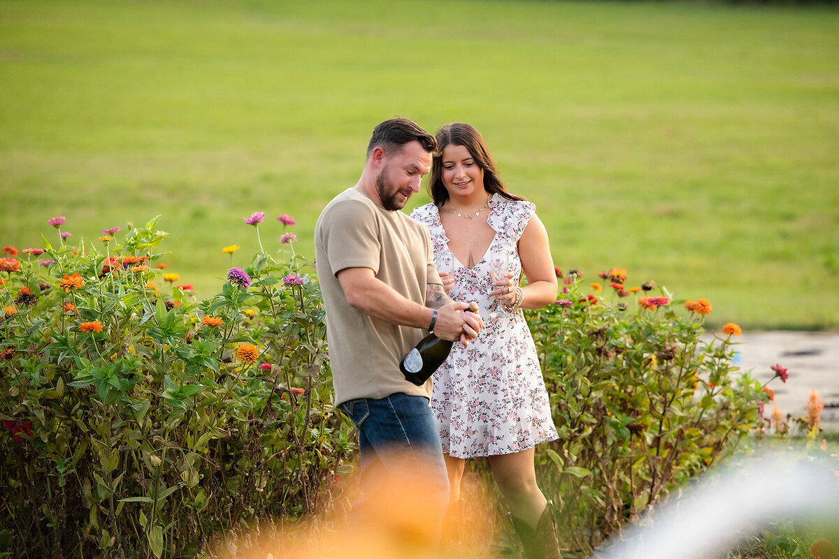 couple celebrating engagement with champagne