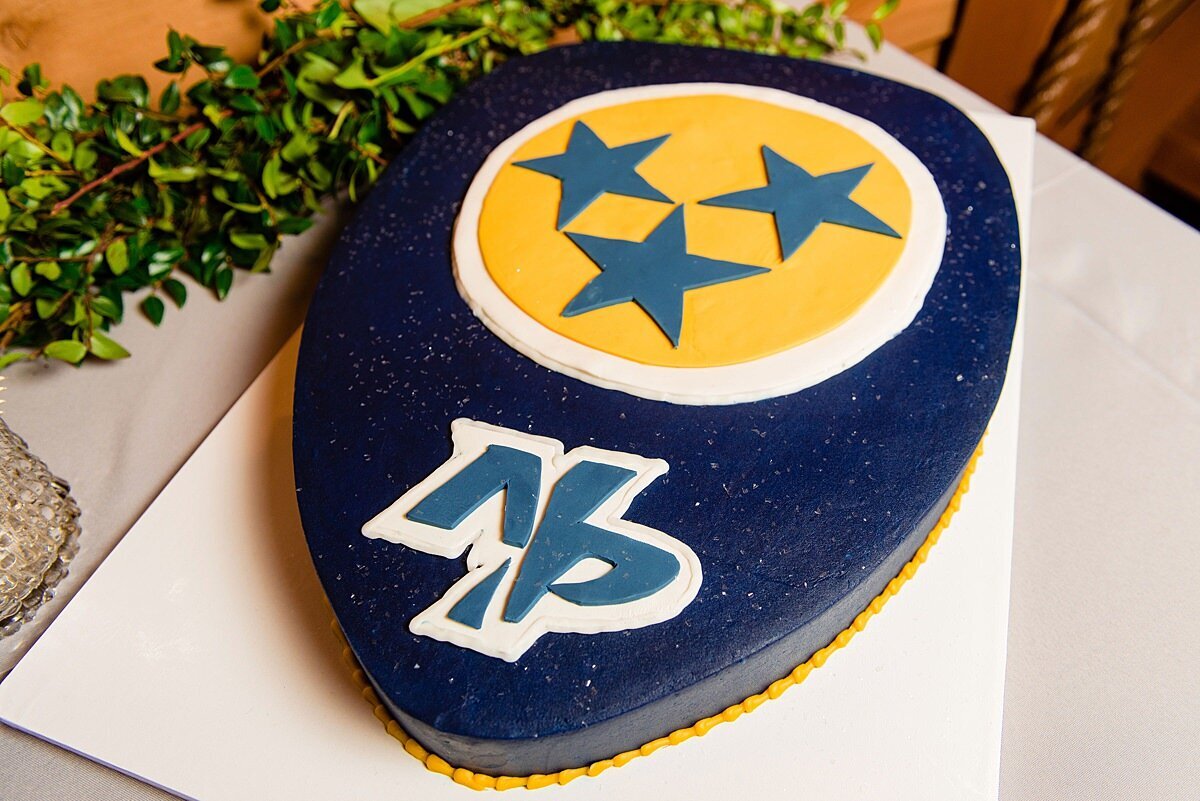 Nashville Predators Hockey themed groom's cake in dark blue and yellow witht he tennessee tristar logo