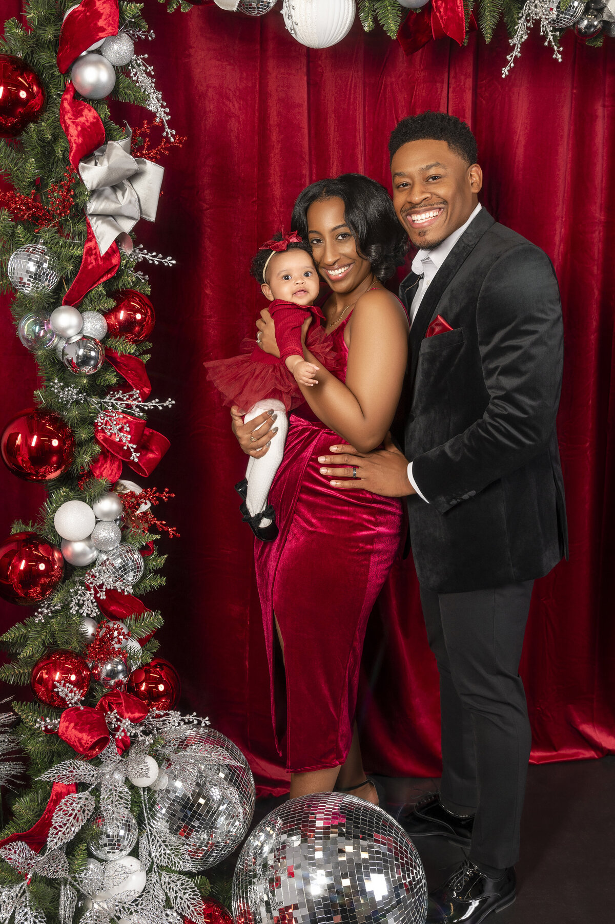 Couple poses for natural maternity photos in black-owned photography studio
