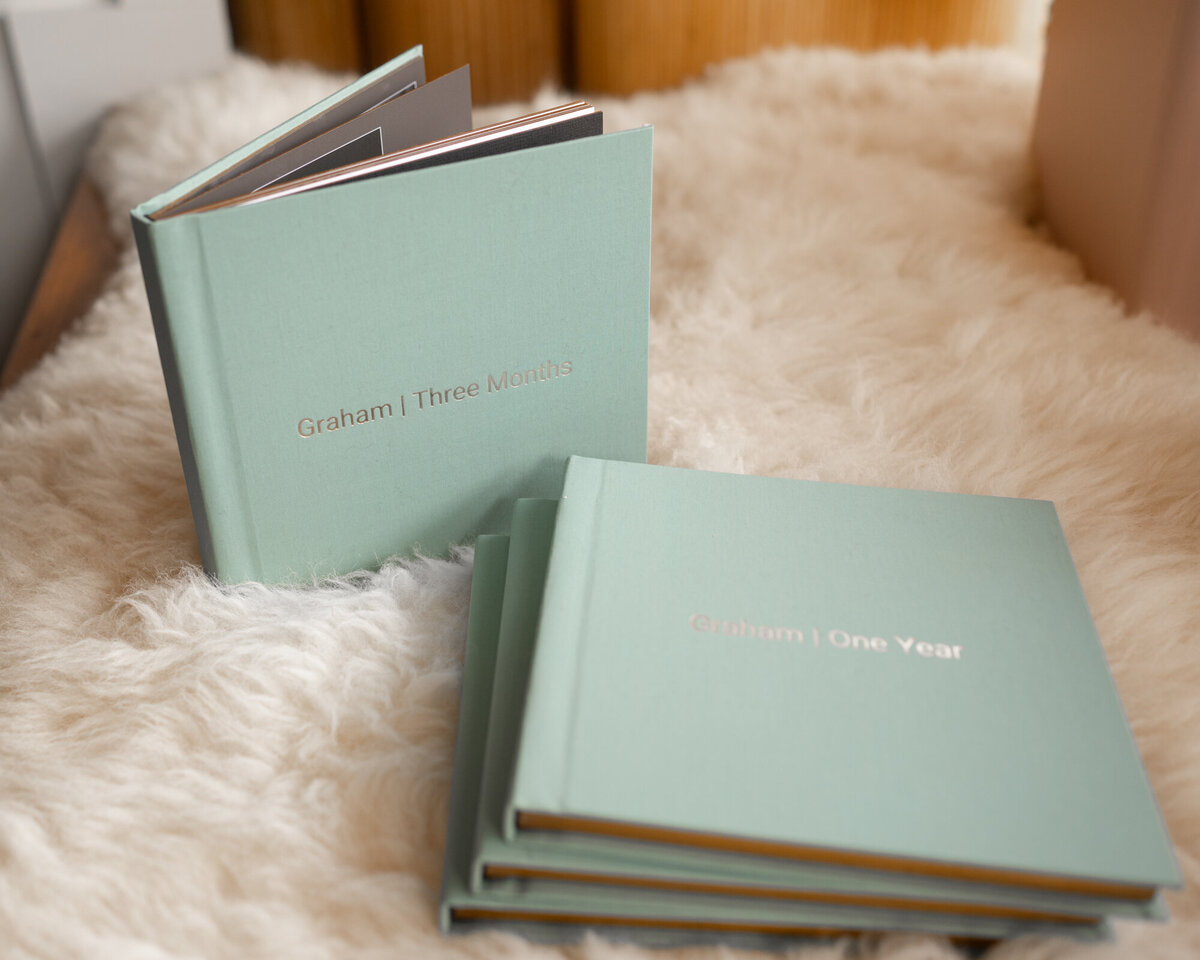 A stack of mini albums on white fur blanket