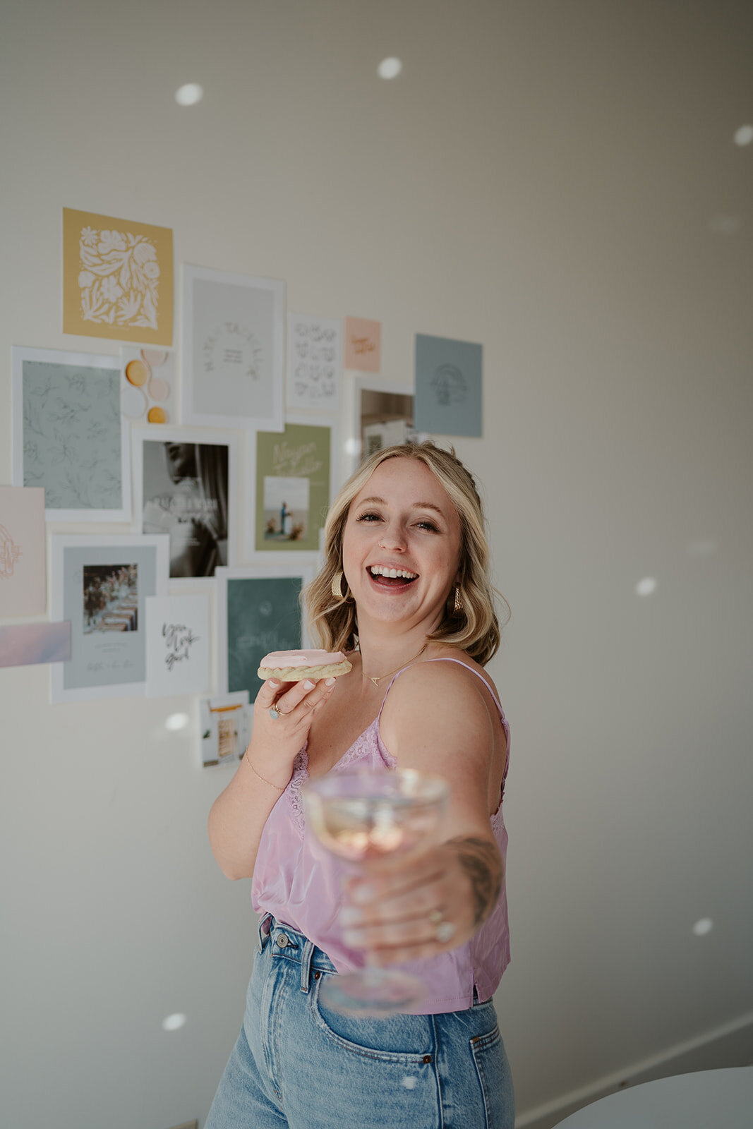 Photo of a woman tossing confetti in a bright studio during a Wildher and Co branding session in Kalamazoo Michigan.