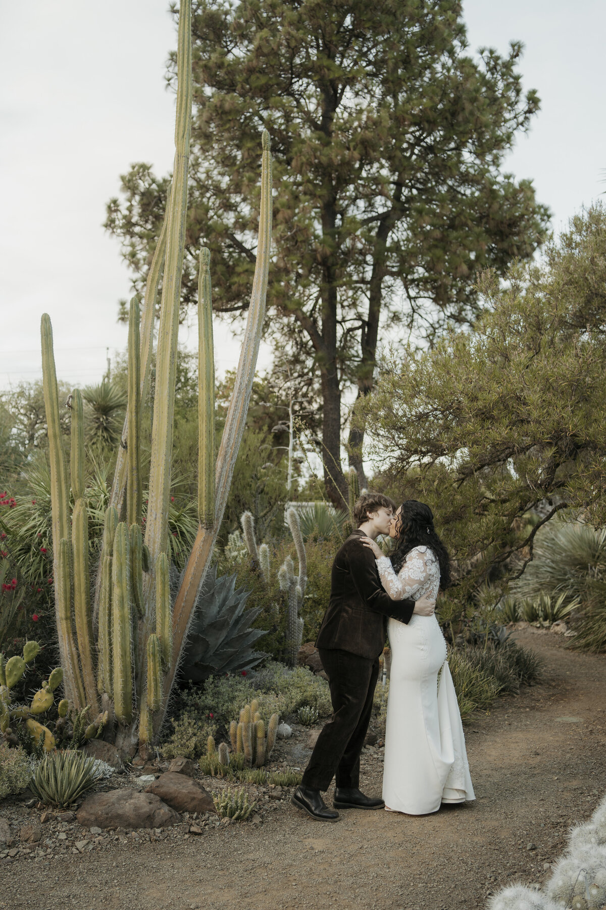Brides kiss by cacti at their wedding at Ruth Bancroft Botanical Garden in Walnut Creek, CA