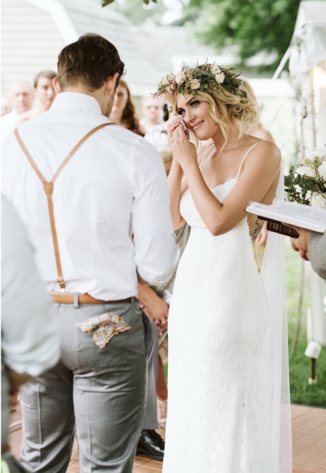 Bride wiping tears during ceremony