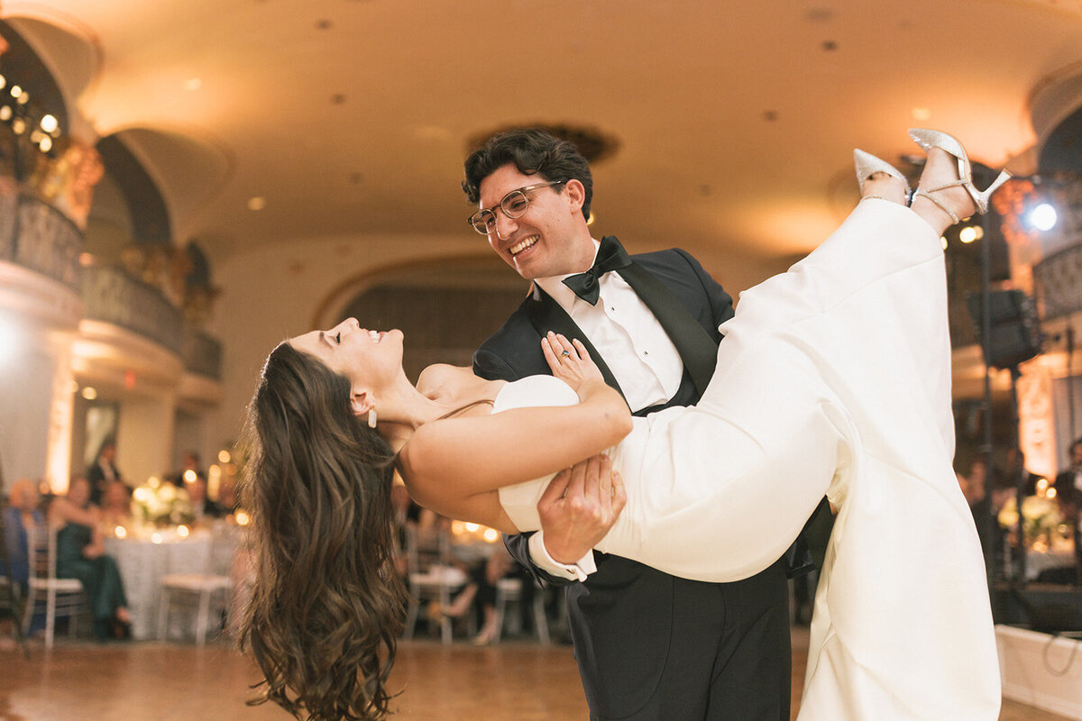 Wedding couple dancing a lift during first dance