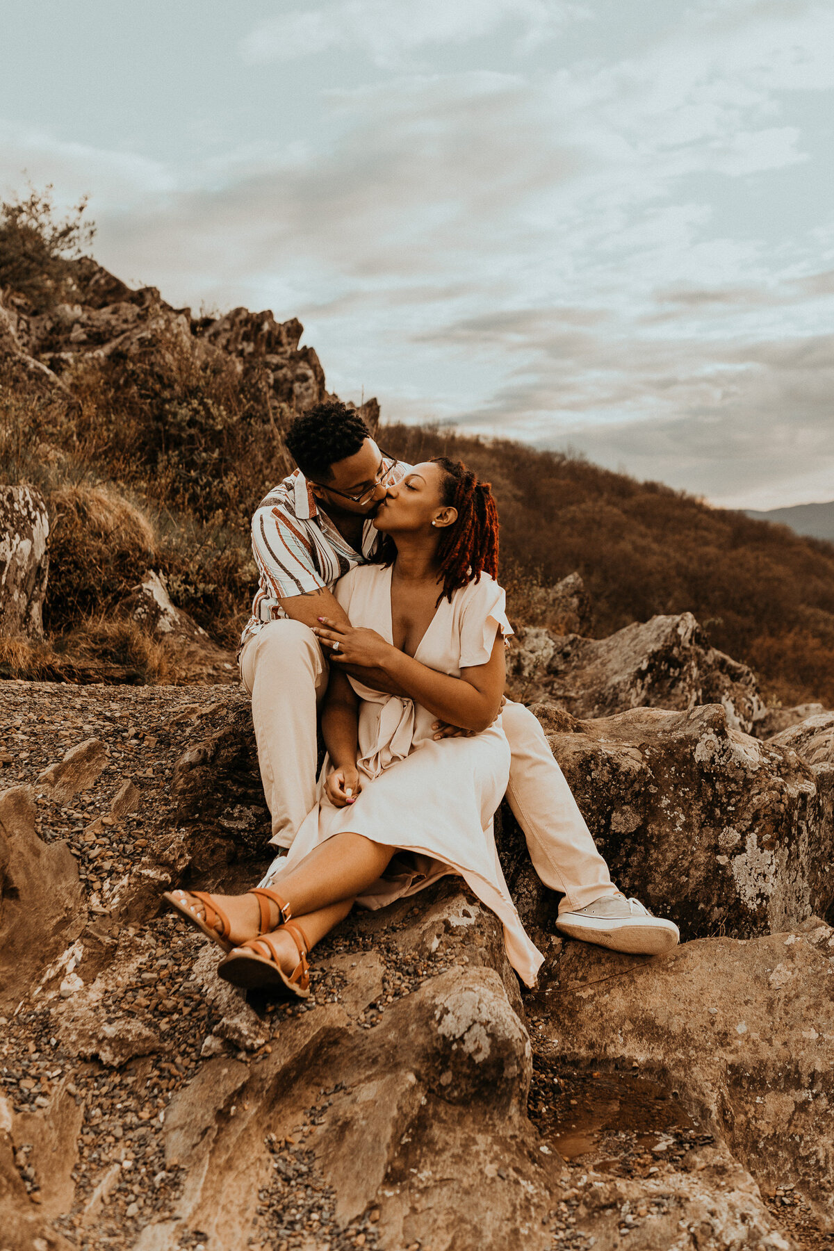 couple sits on mountaintop