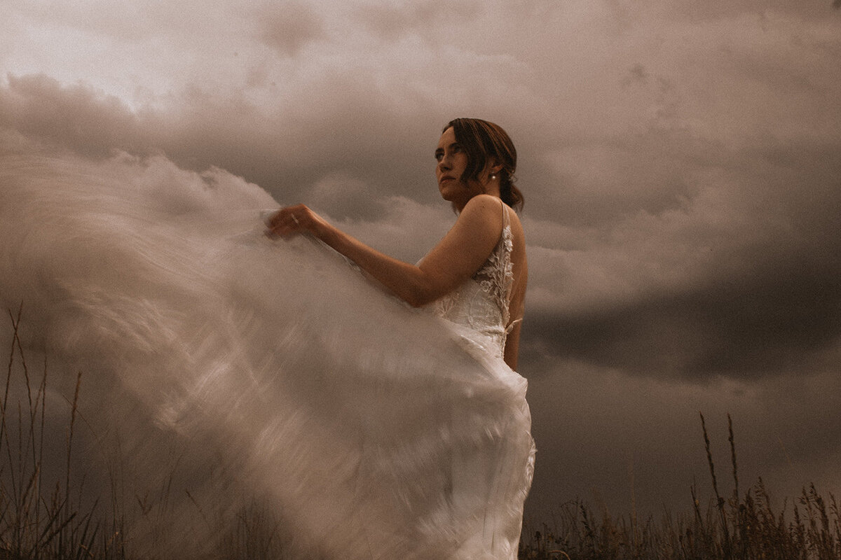 bride throws wedding dress to create motion blue