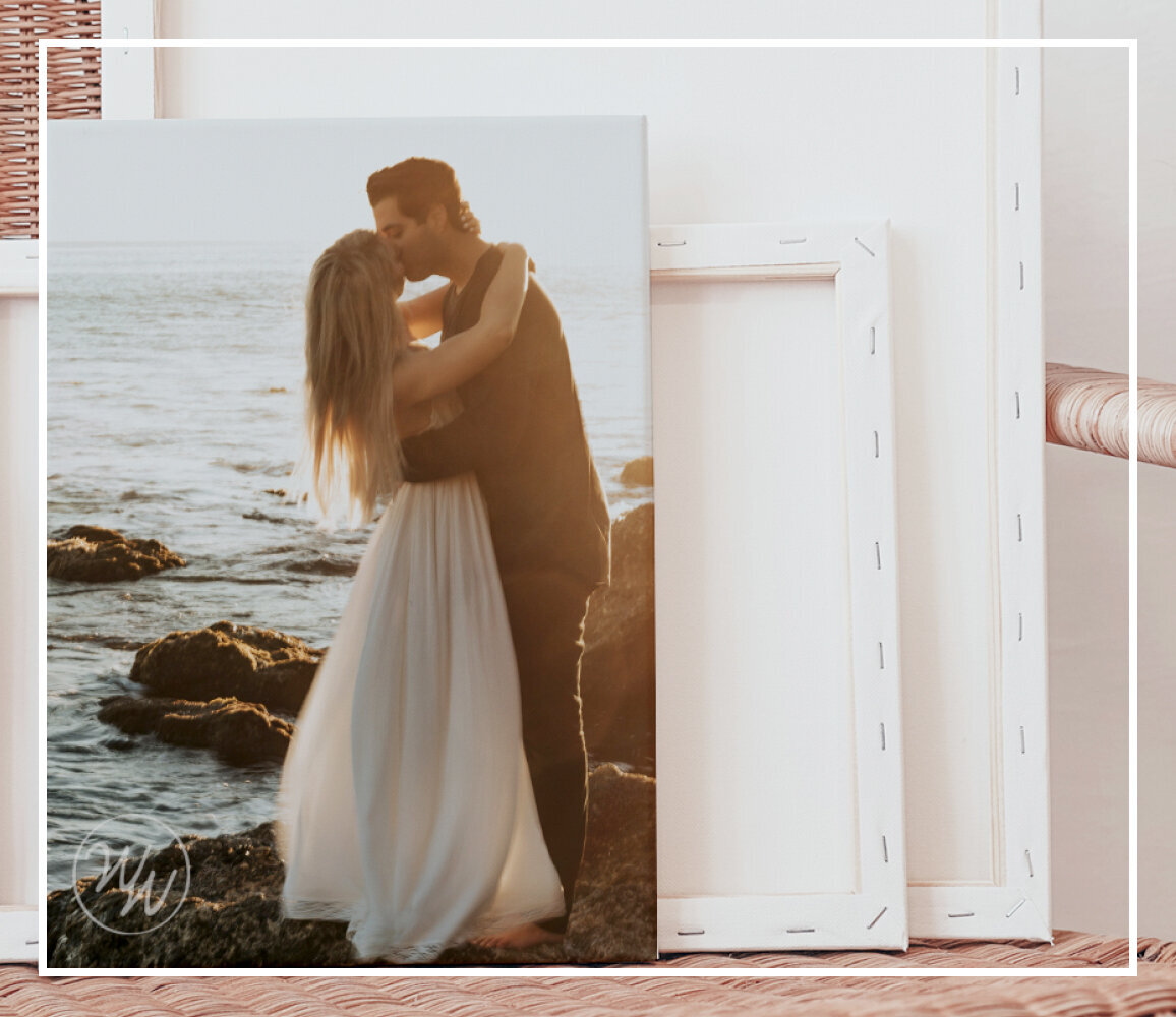 Canvas of a married couple sits on a boho chair.