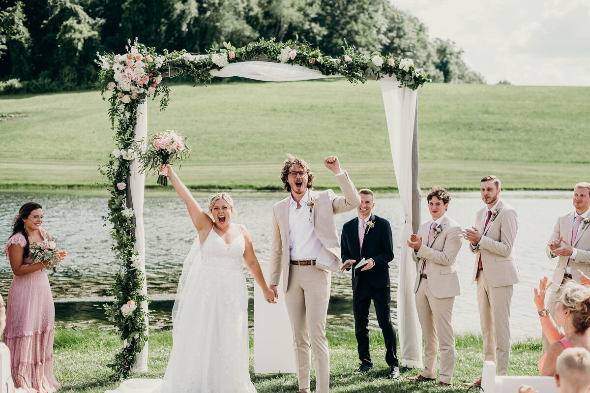 Bride and groom exiting the ceremony as newlyweds, surrounded by confetti and laughter | Pittsburgh Wedding Photographer