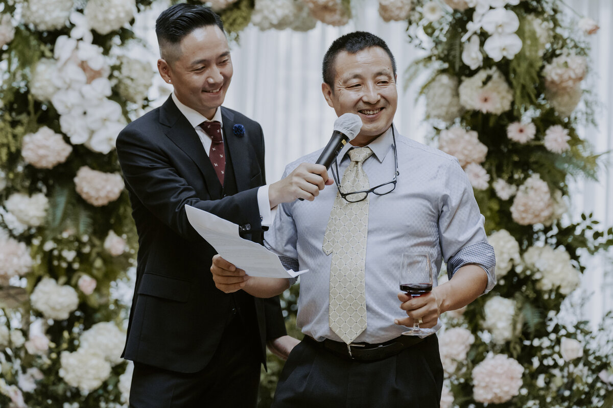 a guy holding a mic for the father's speech