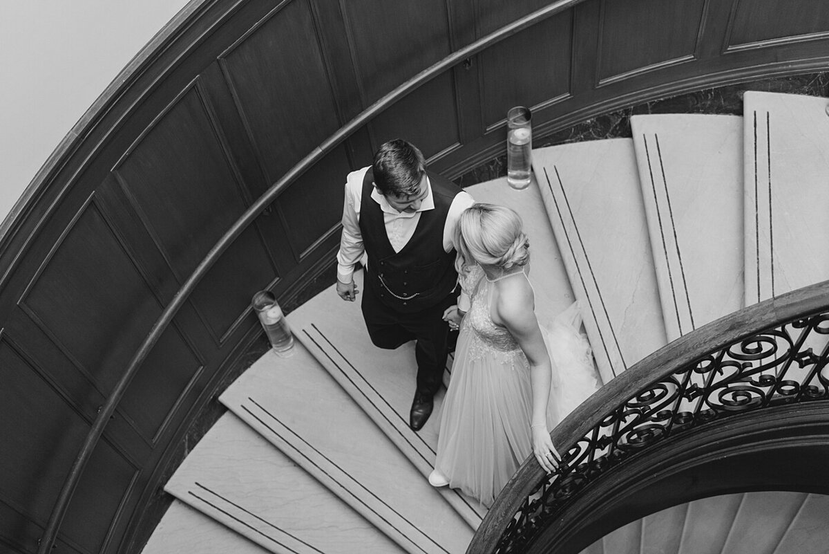 Ohio Wedding Photographer captures bride and groom walking out of their reception to meet guests at the after party at the Athletic Club of Columbus at a Columbus, Ohio wedding