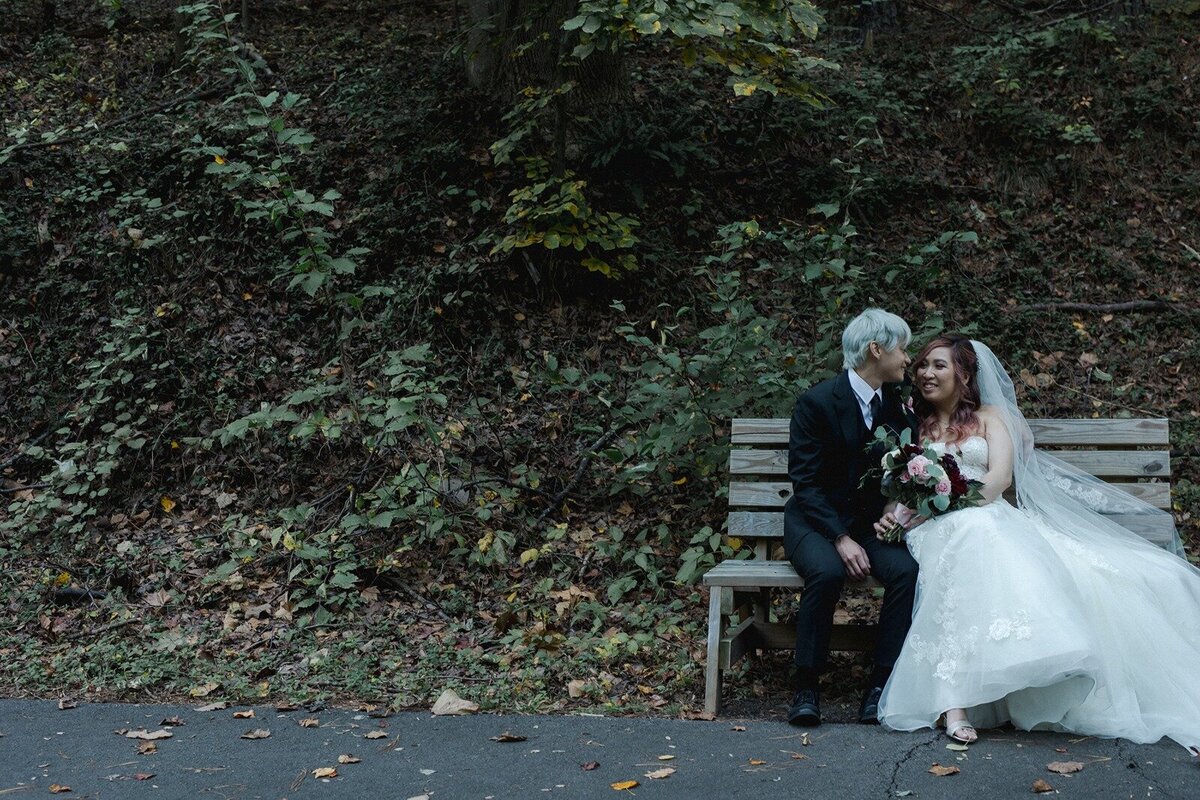 Wedding couple sitting on a bench