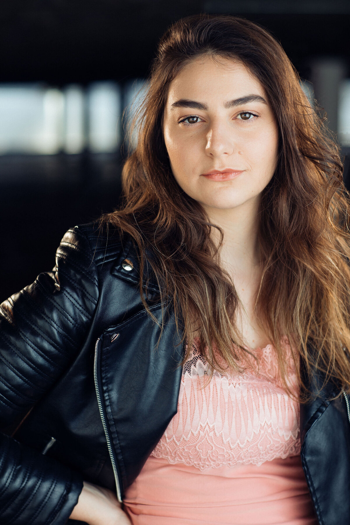 Headshot Photograph Of Young Woman In Outer Black Leather Jacket And Inner Pink Blouse Los Angeles