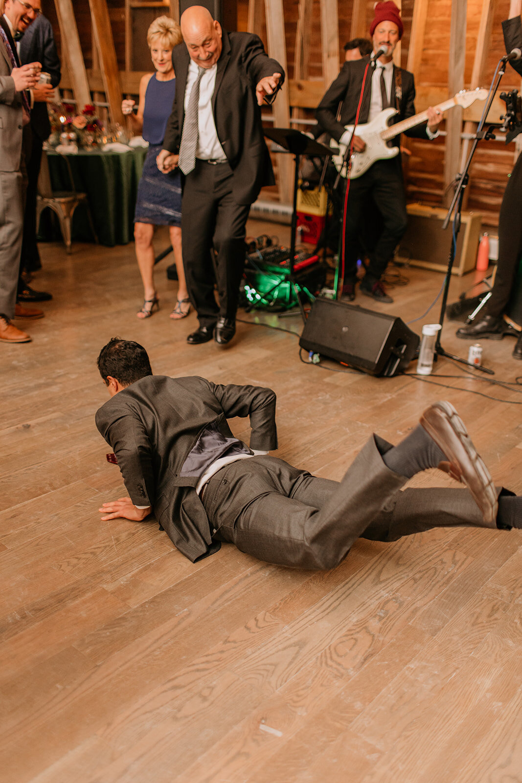 Wedding guest doing the worm on the dance floor at The Farm at Glenwood Mountain.

