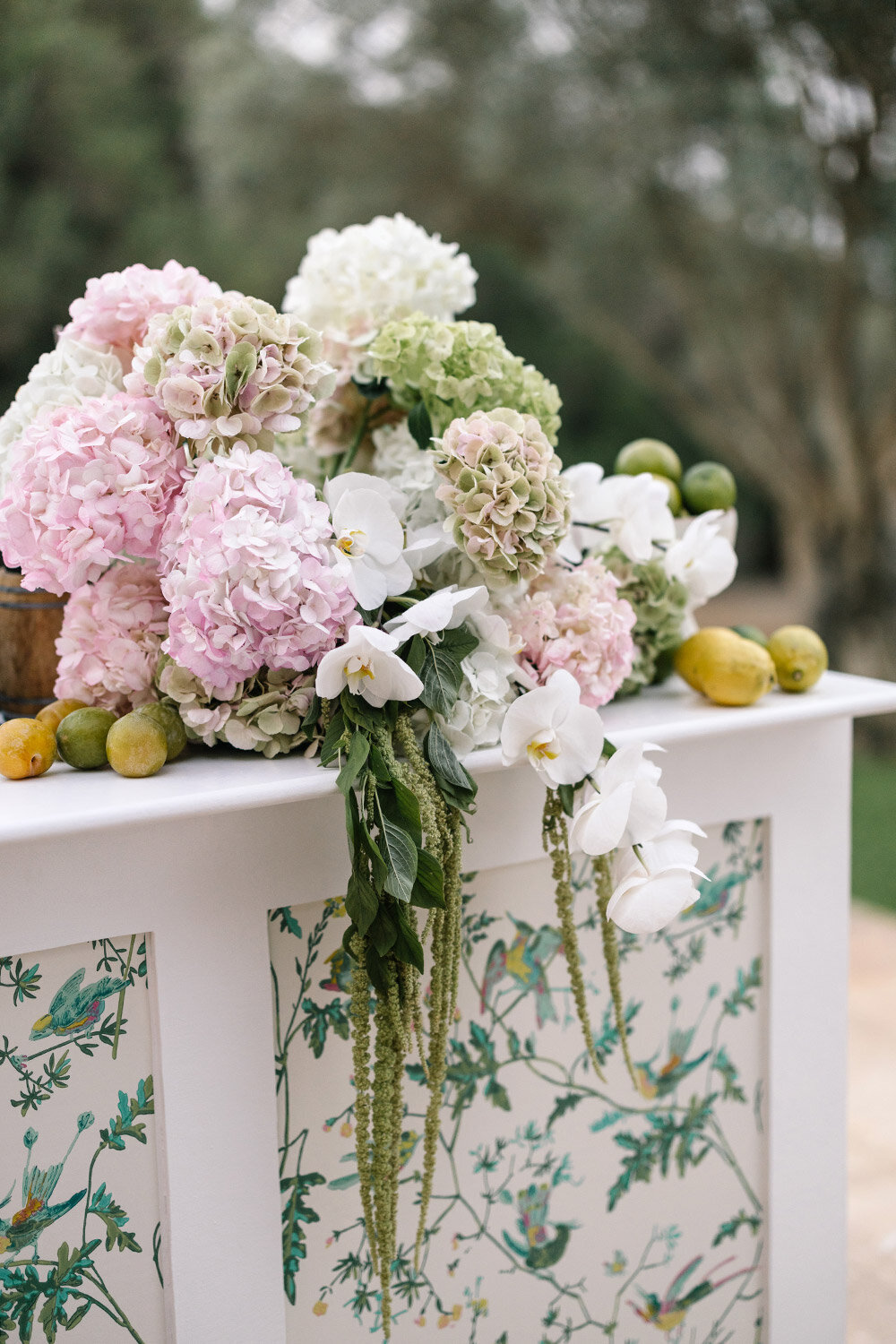 white orchids and pink hydrangeas on custom wedding bar