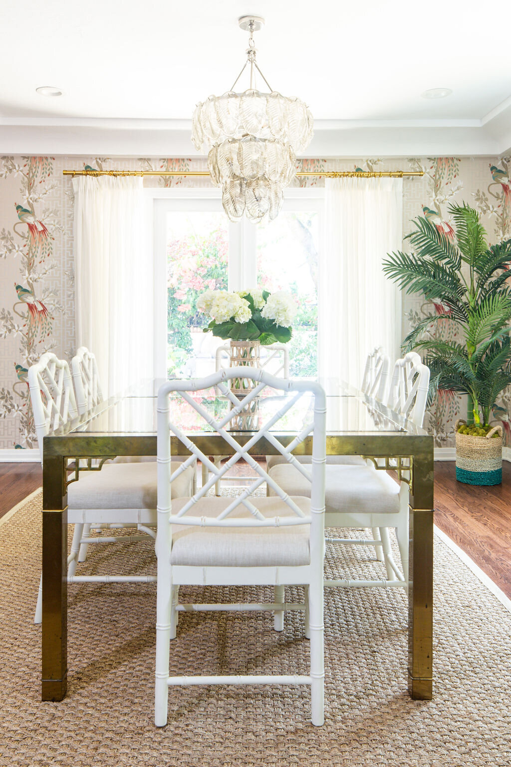 Dining Room with Mastercraft brass and glass dining table, jute rug, Chippendale dining chair and Nina Campbell Paradiso wallpaper.