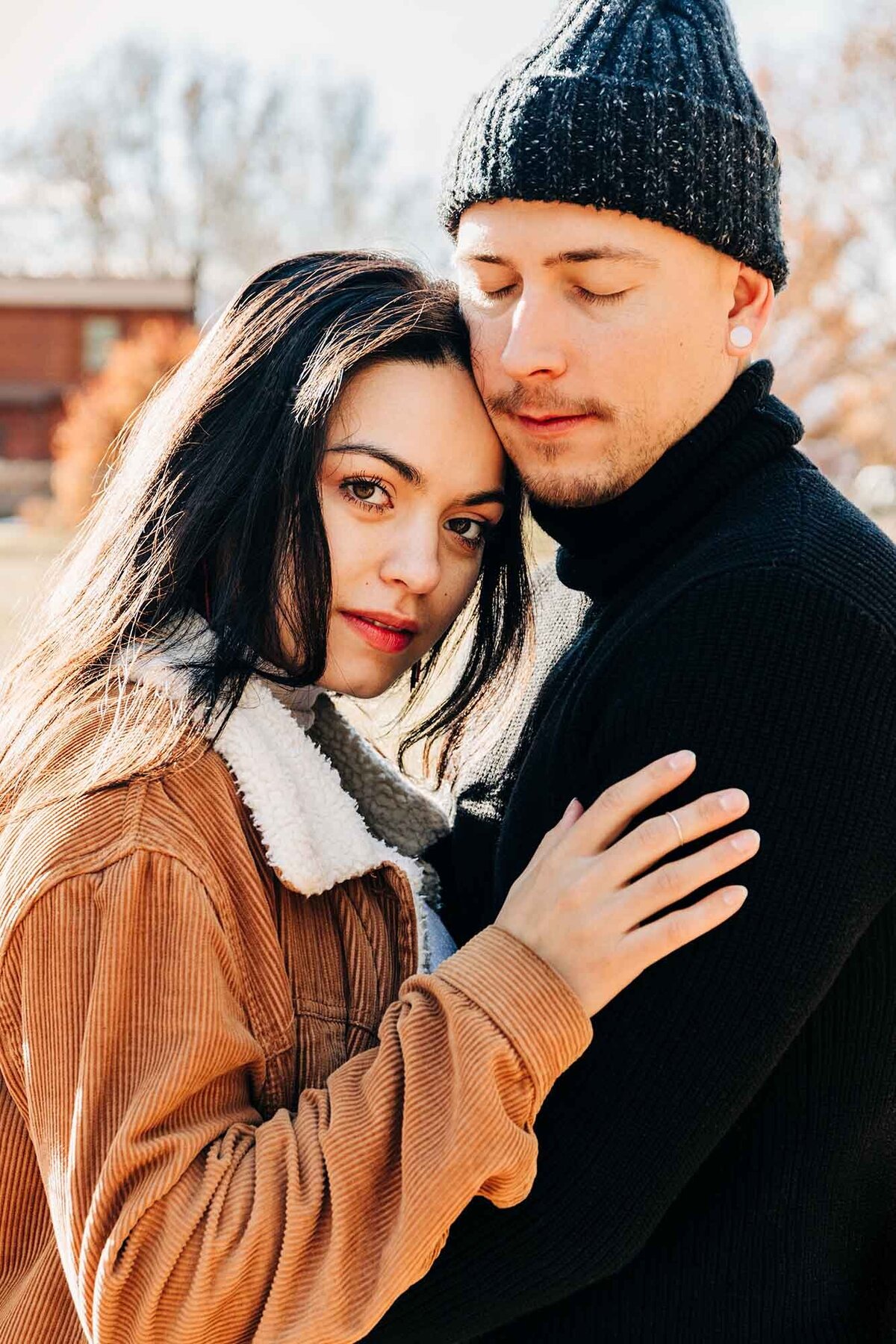 Missoula couple embracing intimately outside of fall day