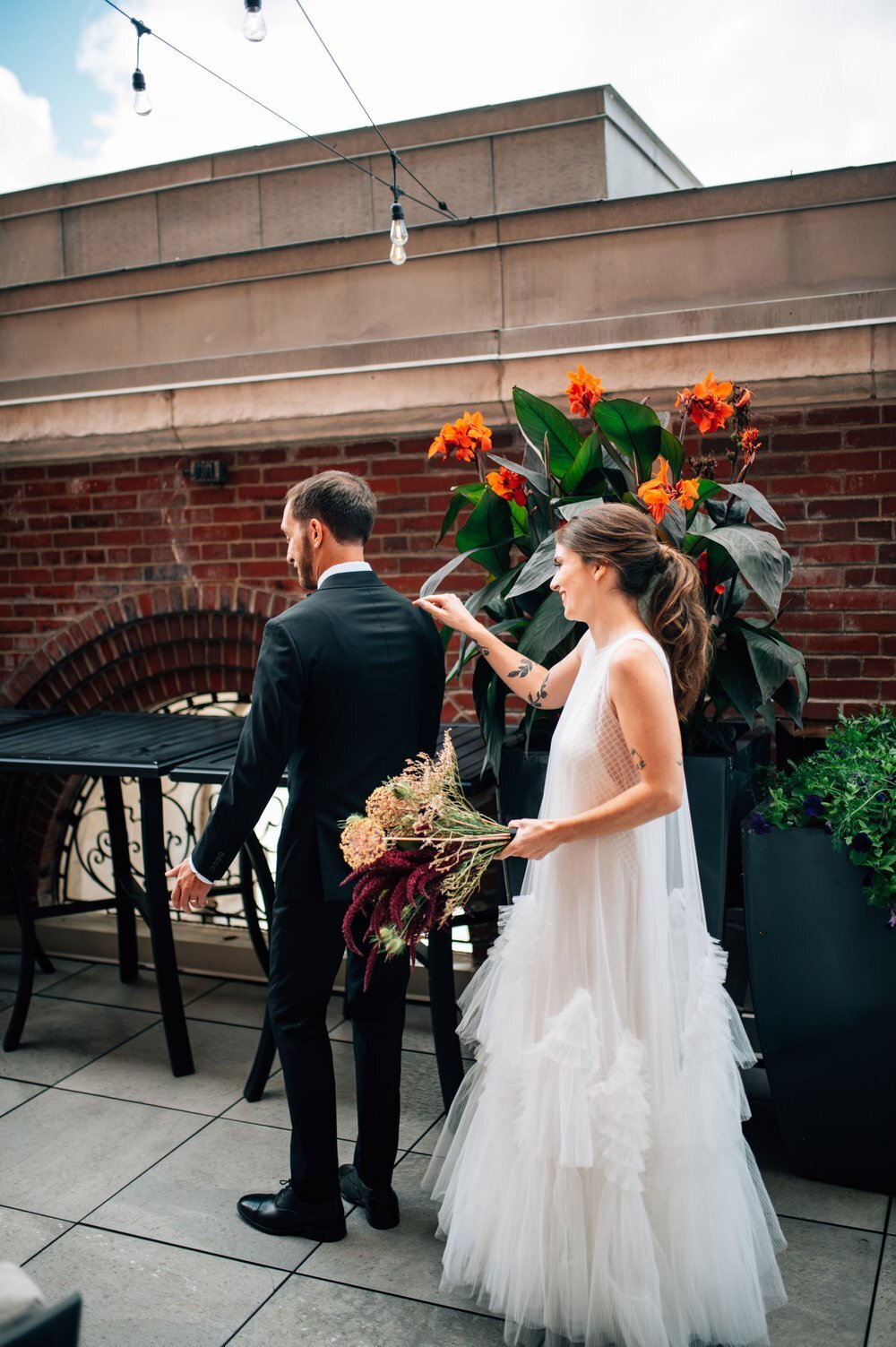 Bride tapping groom on shoulder